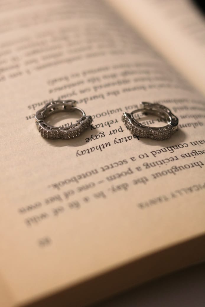 Shimmering silver hoops adorned with sparkling, eye-catching stones