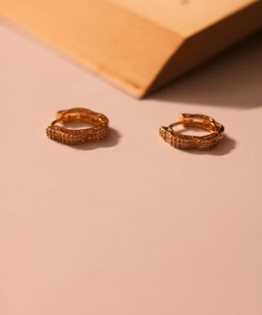 Chic gold hoops adorned with elegant, light-catching accents