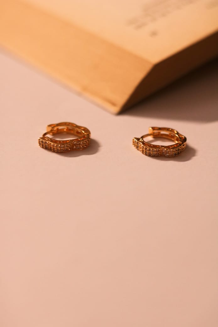 Chic gold hoops adorned with elegant, light-catching accents