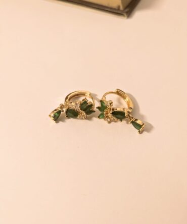 Elegant gold-tone hoops with lush green gemstone drops—timeless sparkle for every vibe