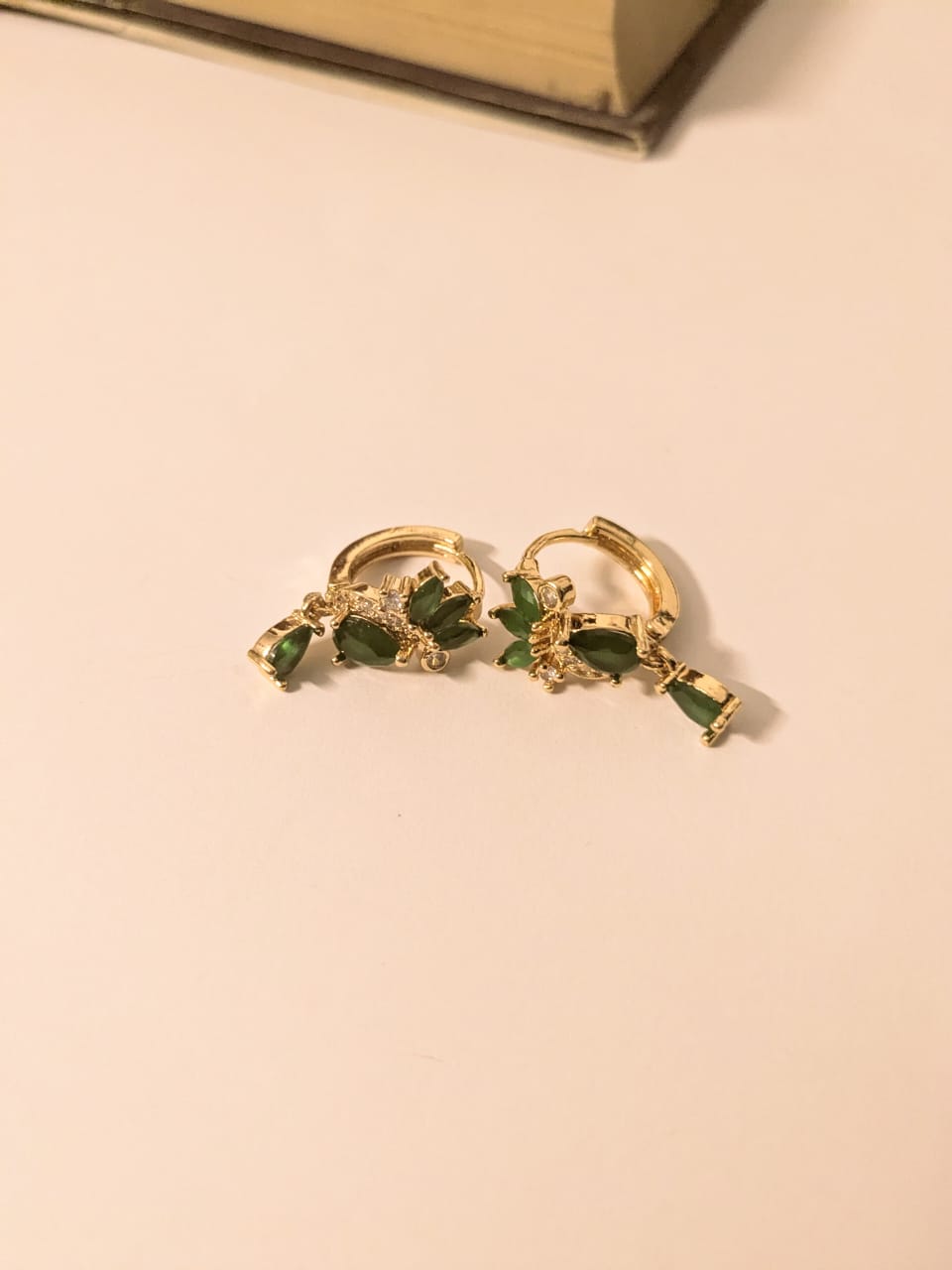 Elegant gold-tone hoops with lush green gemstone drops—timeless sparkle for every vibe